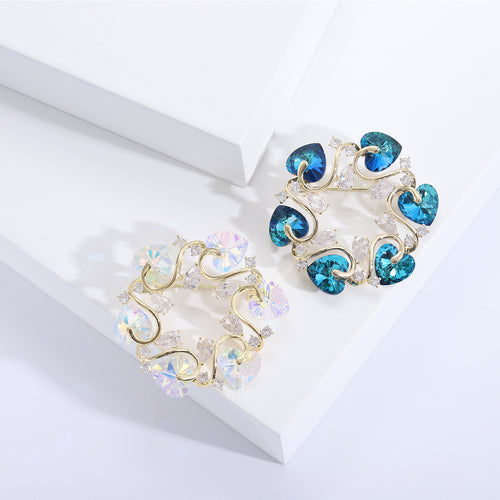 AB and blue heart crystal wreath brooches on white blocks
