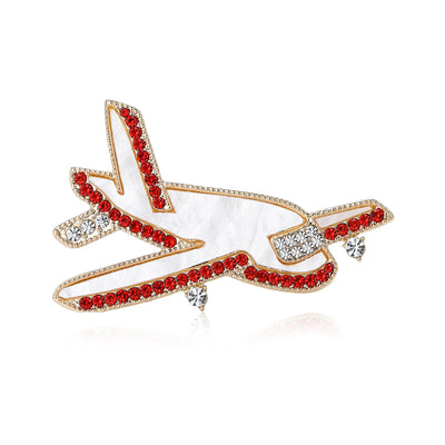 Crystal Airplane brooch styles arranged on a light display