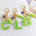 Green Glitter Letter Keychain with Evil Eye Charm and Suede Tassel view 1