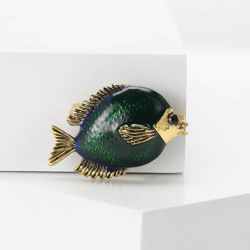 Front view of a rounded dark green fish with textured gold-tone fins