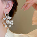 Gold Tone Bow Earrings With White Pearl And Crystal Clusters view 3