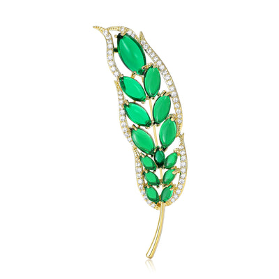 Front view showing the gold tone green leaf brooch with marquise crystal inlays