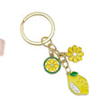 Gold-Tone Enamel Lemon Keychain With Citrus Slice Flower And Butterfly Charms view 5
