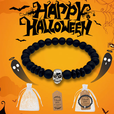 A black skull bead bracelet is shown on an orange Halloween background beside a white pouch and brown tag.