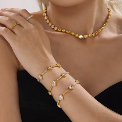 Model wearing three gold heart zircon bracelets stacked on wrist
