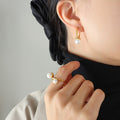 Gold Oval Huggie Hoop Earrings White Glass Pearl Drop view 1