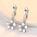 White Flower Charm Huggie Hoop Earrings in Silver Tone view 3