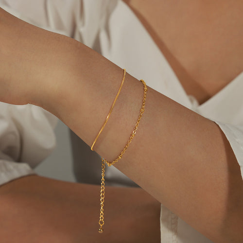 Gold double layer snake and bead chain bracelet on wrist