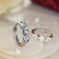 Silver Tone Five Graduated Clear Stone Huggie Hoop Earrings view 1