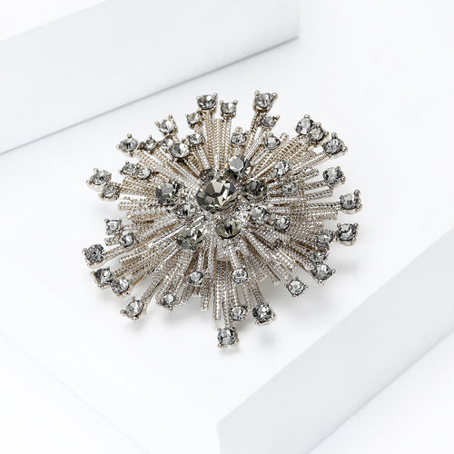 Angled display of round starburst composed of radiating rows of clear stones