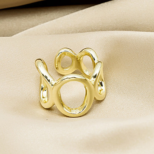 Gold open abstract multi-loop ring on beige satin fabric