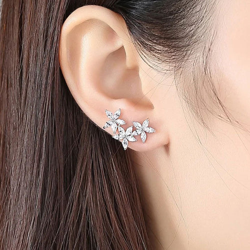 Flower cluster studs worn on ear lobe close-up