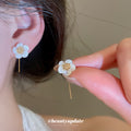 White Flower Hook Earrings in Silver and Gold with Polished Metal Details view 3