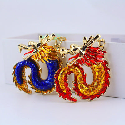 Two red and blue dragon charms displayed together against a white backdrop.