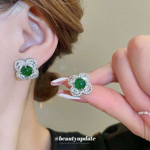Second listing image of silver crystal flower green stud earrings, showing the visible finish.