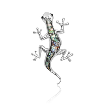 A slender lizard with an iridescent shell inlay shown on a white background.