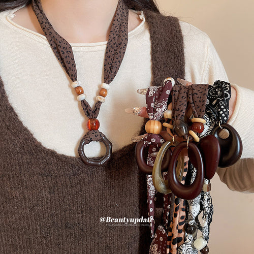 fabric cord necklaces with large geometric resin pendants shown in the main product view