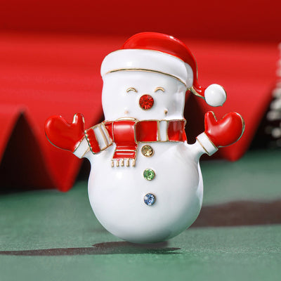 A white snowman with red hat, scarf, mittens and crystal buttons shown on a white background.