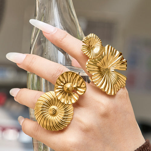 Grouped style view of textured disc and flower statement rings in main image 2.