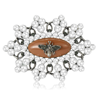 Front view of the crystal bee brooch with brown or blue center with polished metal detail on a white background