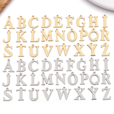 Metallic alphabet letter charms arranged on a light background