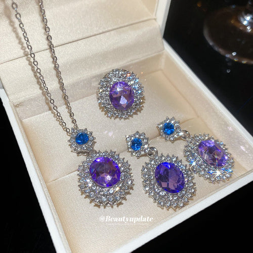 Purple oval crystal halo necklace earrings and ring set in cream box