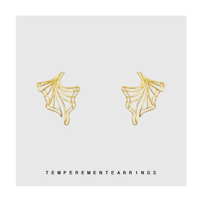 Gold geometric skirt swing earrings pair on light gray card