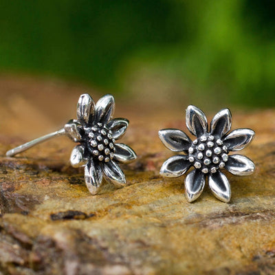 antique silver tone earrings showing small layered sunflower shapes with darkened centers