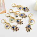 Hamsa Hand and Evil Eye Charm Keychain in Gold and Silver Tone view 1