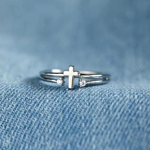 Second product view showing silver-tone cross and clear-stone open double-rail ring