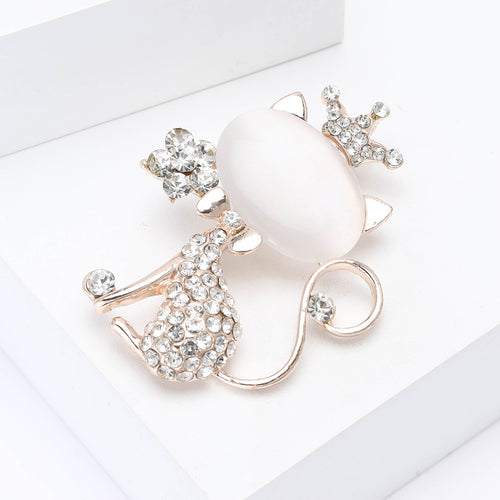 Close-up product view showing the colors and surface details of the white cat brooch