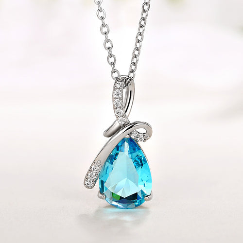 Blue teardrop pendant front close-up on soft light surface