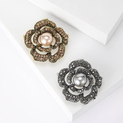 Front view of the layered rose crystal brooch with pearl center in two finishes brooch and its color options