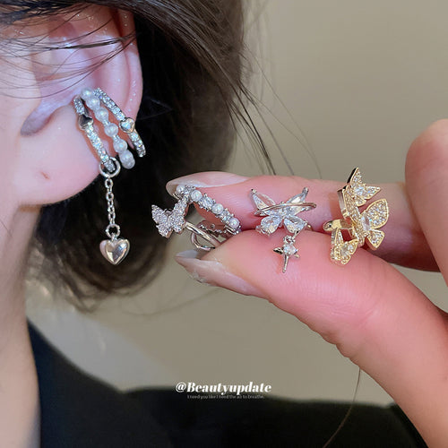Styled view of butterfly pearl ear cuffs in six silver and gold tone styles
