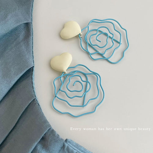 Pair of cream heart studs with blue wire roses on white