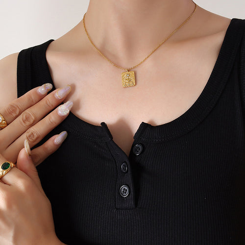 Gold square sun hand pendant necklace worn on black tank