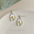 Silver Tone Oval Frame White Flower And Green Leaf Stud Earrings view 1