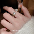 Textured Gold Tone Open Ring With Two Unequal Pearl Like Ends view 2