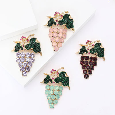 Front product view of the crystal grape cluster brooch on a light background