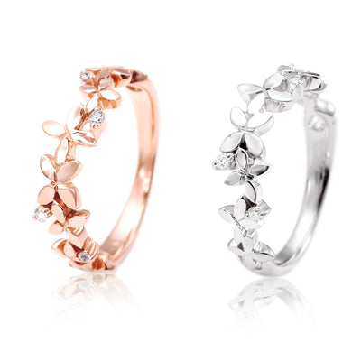 Rose gold and silver butterfly flower band rings side by side