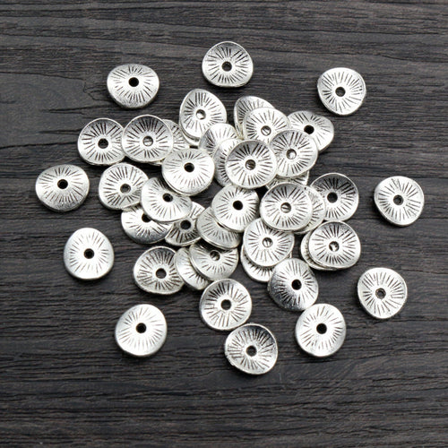 Curved Rolled Edge Round Spacer Discs in Antique Silver shown close up