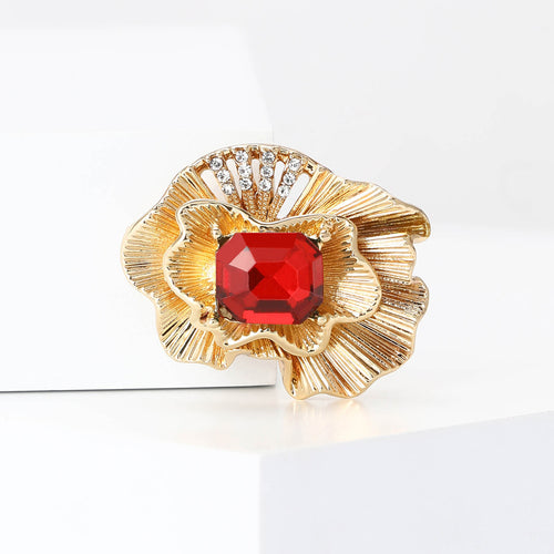 Red emerald-cut gold ruffled flower brooch angled studio view