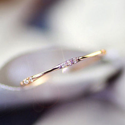 Product view showing ultra-slim clear-stone wave ring