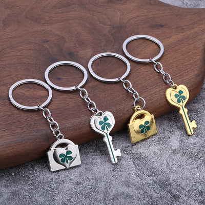 Gold-tone and silver-tone heart lock and key keychain pairs on a wooden surface.