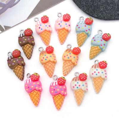Multicolor ice cream and strawberry charms arranged on a light background