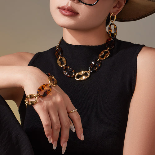 Model wearing leopard resin link necklace bracelet and earrings