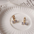 Gold-Tone Huggie Hoop Earrings Clear Crystal Bow Charms view 4