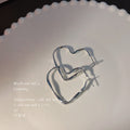 Silver Twisted Open Heart Huggie Hoop Earrings Outline view 1