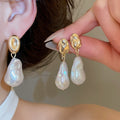 Gold Tone Baroque Pearl Drop Earrings With Polished Metal Details view 1