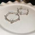 Open Bow Wire Hoop Earrings in Gold and Silver Tone view 8